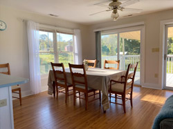 Dining area in main home (larger apartment) overlooks back deck and dog friendly fenced yard.